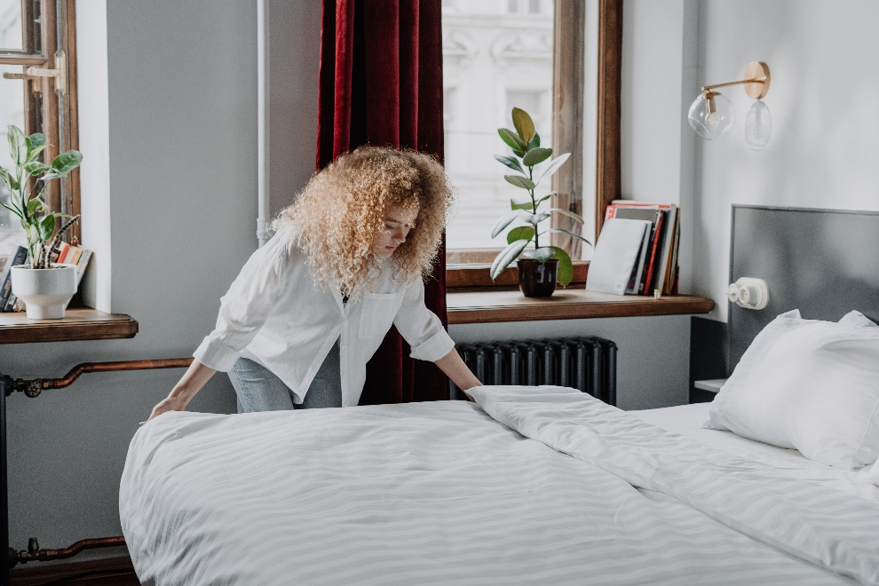 Woman arranging her bedsheet